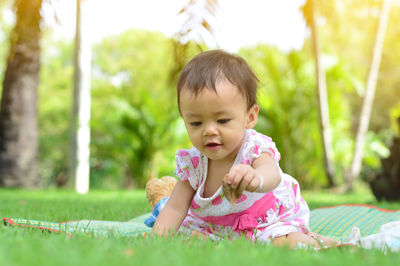 Baby girl on grassy field