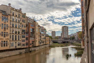 Buildings by river against sky, , girona spain