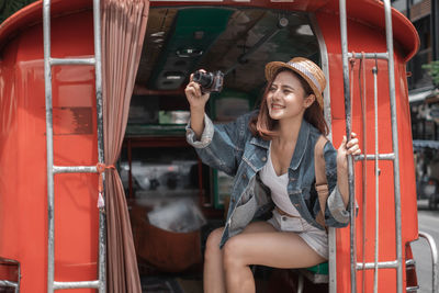 Young woman smiling while sitting in bus