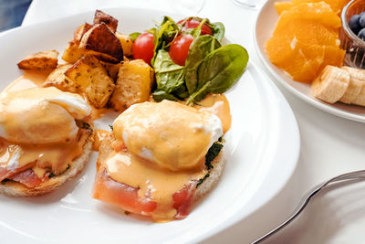 Close-up of sunday brunch. eggs benedict with spinach, salmon and hollandaise sauce