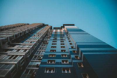 Low angle view of modern building against clear blue sky