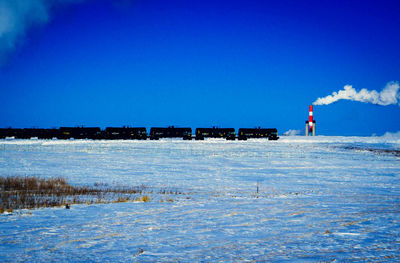 Scenic view of sea against clear blue sky