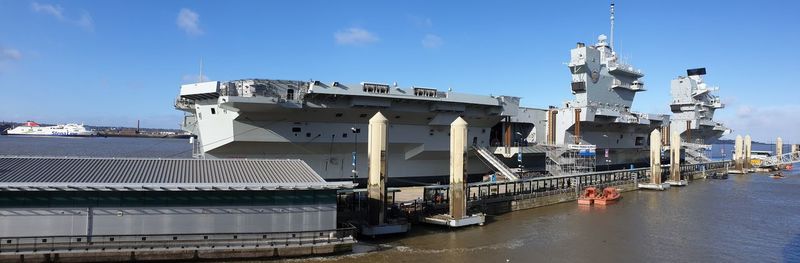 Commercial dock by sea against sky