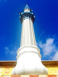 Low angle view of lighthouse against blue sky