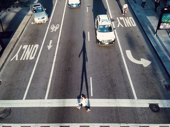 High angle view of woman crossing road