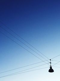 Low angle view of street light against clear blue sky