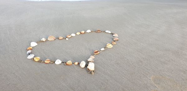 High angle view of heart shape on sand at beach