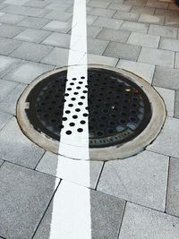 High angle view of manhole on street