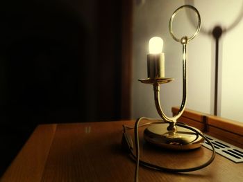 Close-up of illuminated lamp on table