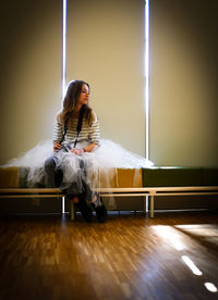 Thoughtful young woman sitting on bench