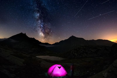 Scenic view of mountains against clear sky at night