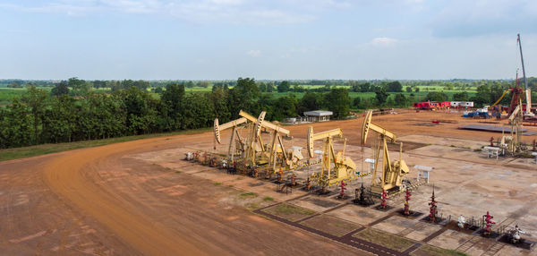 Aerial view of field oil pump jack oil rig machine for pumping natural fossil fuel.