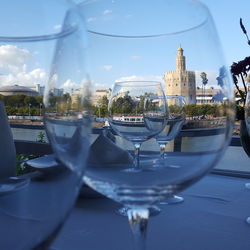 Wineglasses on table against historic building in city