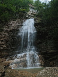 Scenic view of waterfall in forest