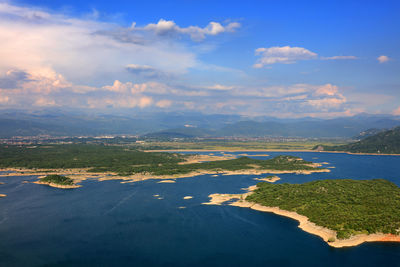 Aerial view of sea against cloudy sky