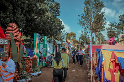 Rear view of people against sky