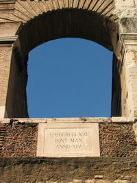 Low angle view of old building against clear blue sky