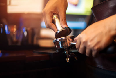 Midsection of man working in cafe