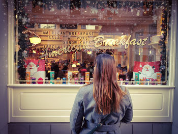 Rear view of woman standing in store