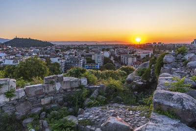 Buildings in city during sunset