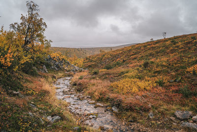 Scenic view of land against sky during autumn