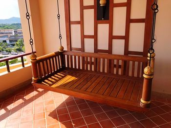 Shadow of railing on tiled floor against building