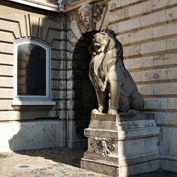 Statue against historic building