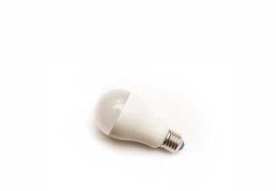 Close-up of light bulb over white background