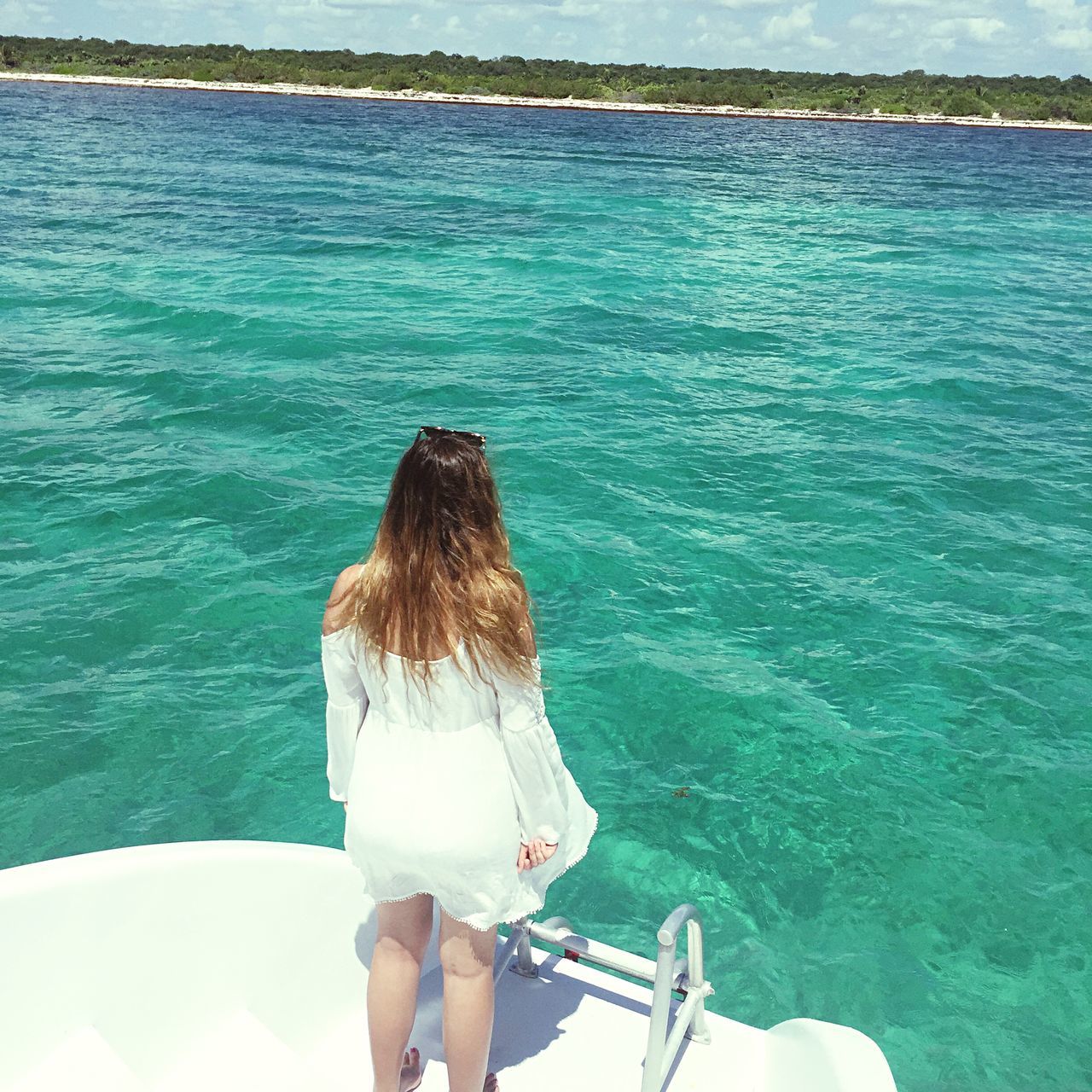 water, sea, leisure activity, lifestyles, rear view, blue, person, vacations, nature, nautical vessel, high angle view, day, long hair, turquoise colored, tranquility, rippled, standing, weekend activities