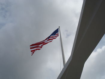 Low angle view of american flag against cloudy sky