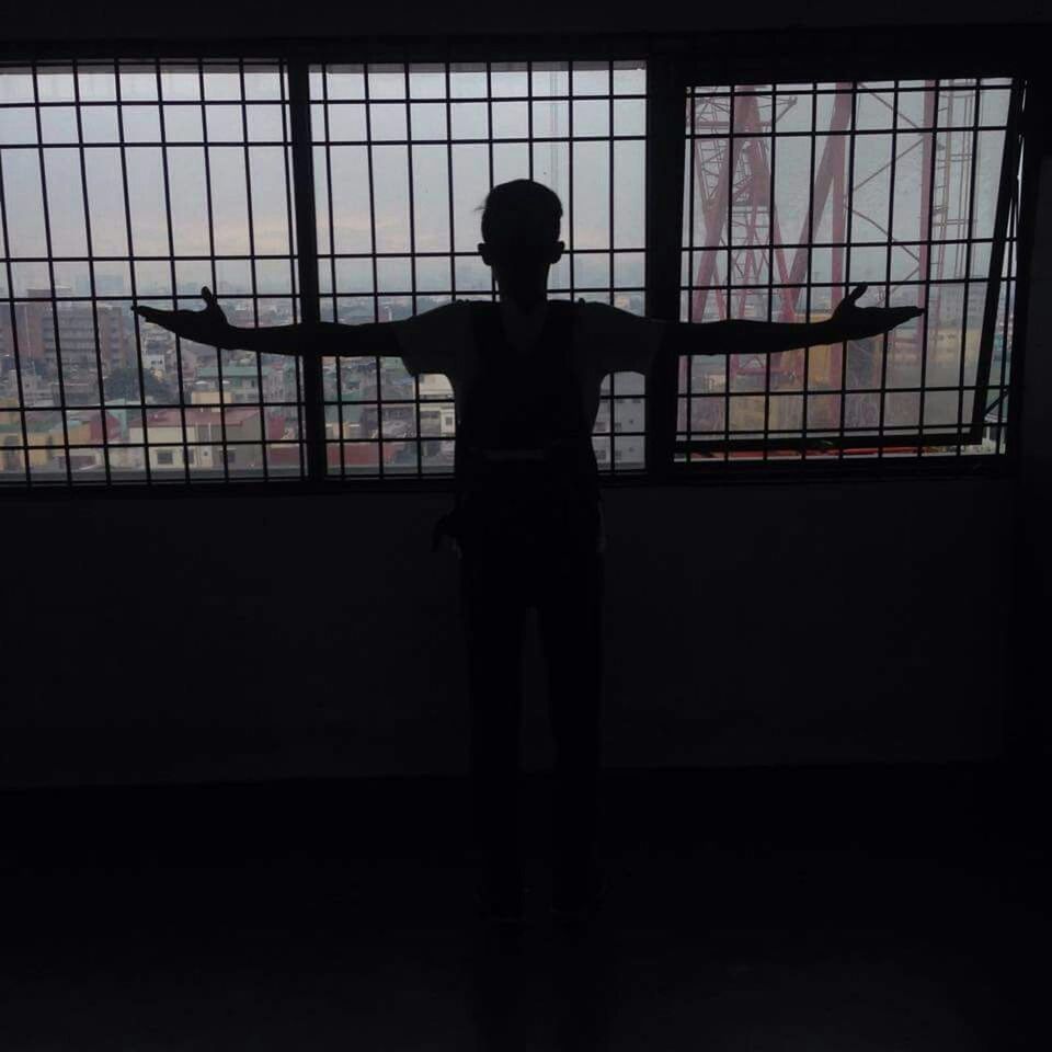 indoors, silhouette, standing, lifestyles, full length, window, leisure activity, three quarter length, rear view, side view, men, built structure, architecture, casual clothing, person, railing, dark, glass - material