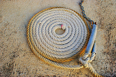 High angle view of rope on textured surface