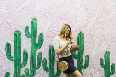 Woman with graffiti on wall