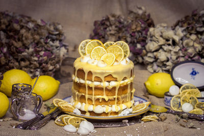 Cake and lemons on table
