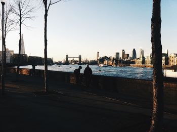 Tower bridge over thames river against clear sky in city