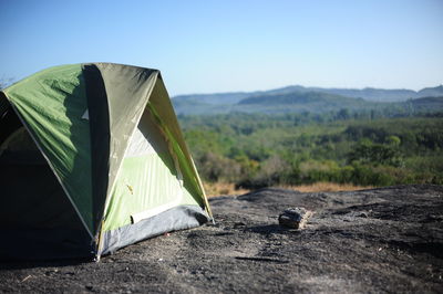 Scenic view of tent on field against clear sky