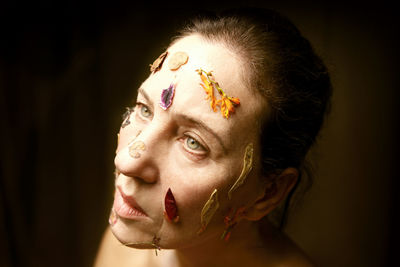 Woman.s face with petals and dry flowers