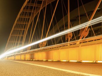 Light trails on bridge in city at night