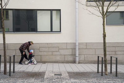 Father teaching daughter to cycle