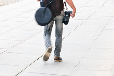 Low section of man and woman walking on road