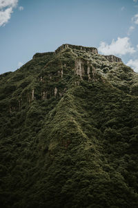 Low angle view of castle on mountain against sky