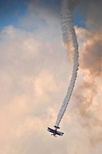 Low angle view of airplane flying against sky