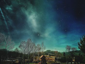 Low angle view of buildings against sky at night