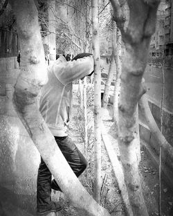Woman standing on tree trunk