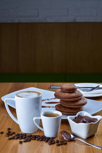 Coffee with cookies on table