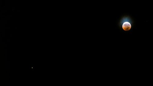 Low angle view of moon against sky at night