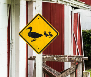 Close-up of yellow sign on road