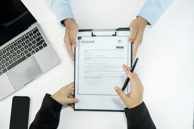 Midsection of man using laptop on table