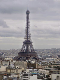 Silhouette of eiffel tower against cloudy sky