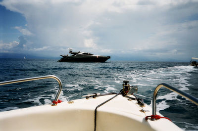 Ship sailing on sea against sky